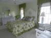 Bright and sunny secondary master bedroom from bathroom doorway
