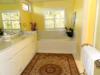 Master bathroom with twin sinks, shower, private toilet, whirlpool tub